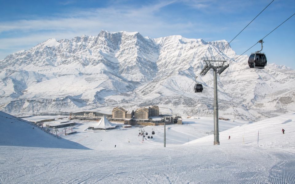 Snowy slopes, modern hotels, and the Caucasus Mountains of the Shahdag resort