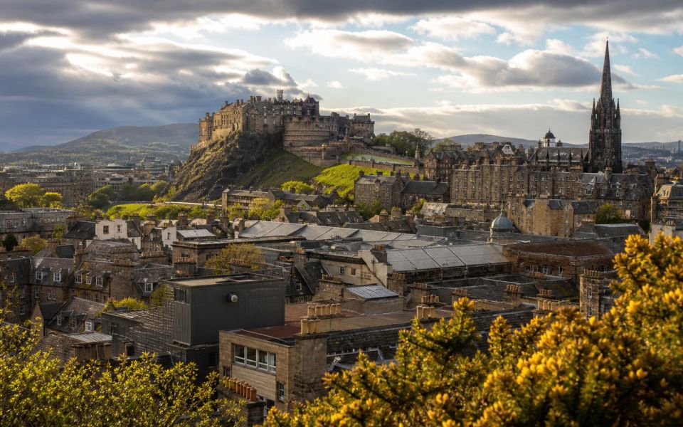 Edinburgh Castle, the stone roofs of the Old Town and green hills