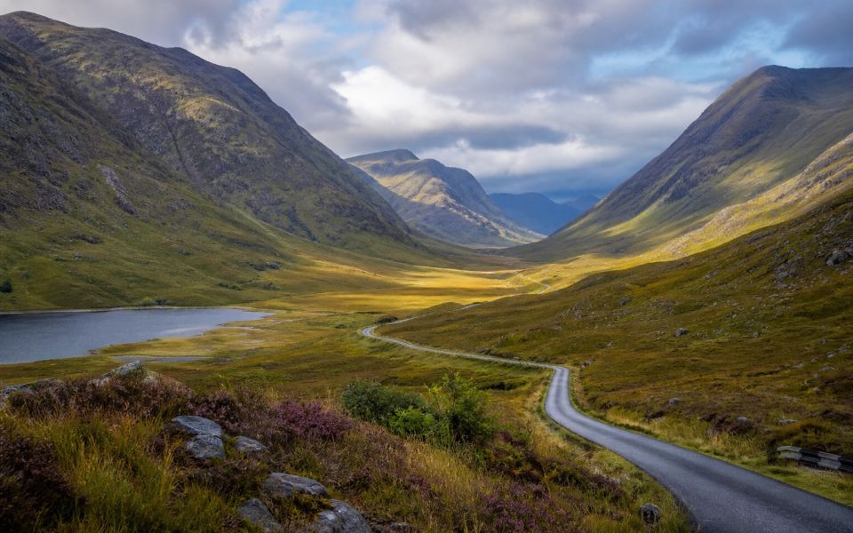 A mountain valley, a lake and a winding road in the Scottish Highlands