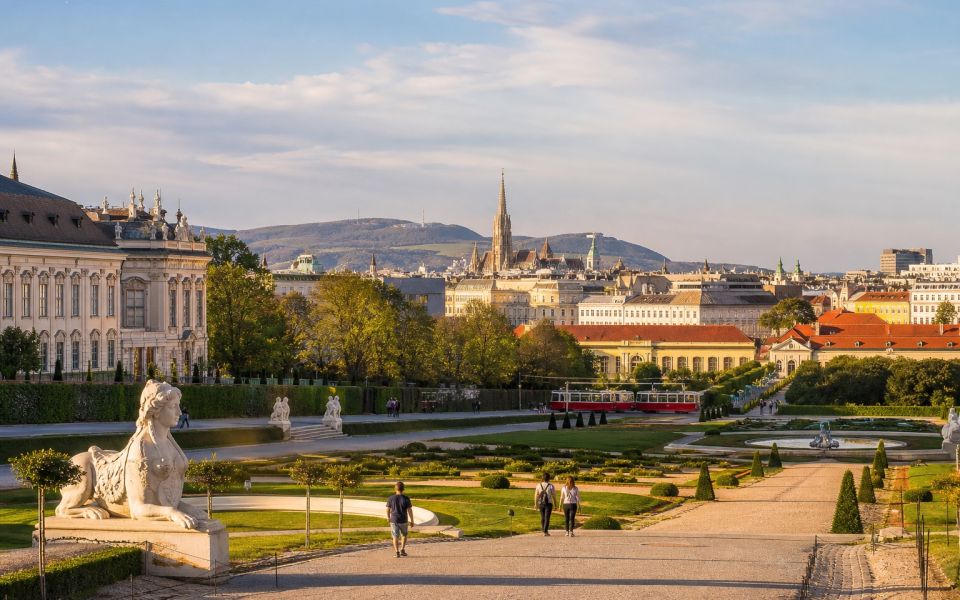 The Belvedere Palace Gardens, the historic center, and a red tram in Vienna