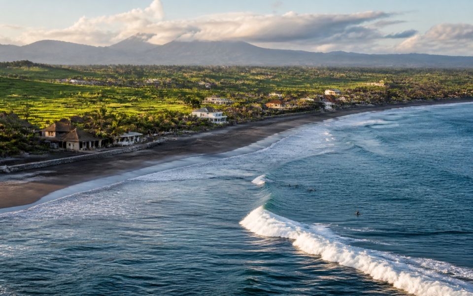 Surfers, a volcanic beach, and rice fields in Bali's Canggu area