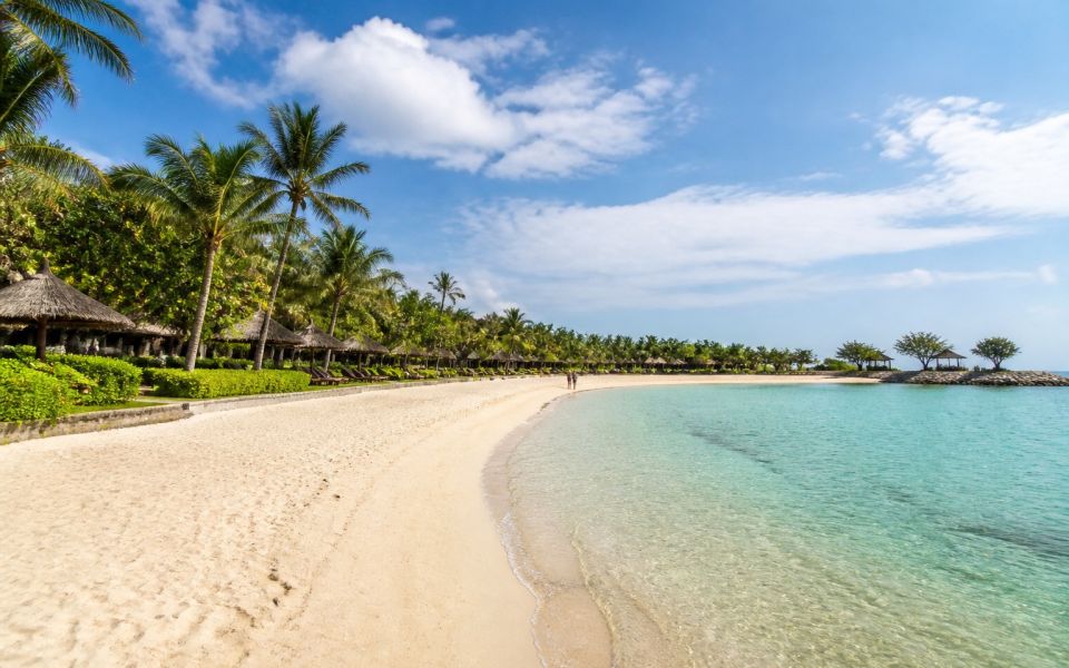 The tranquil lagoon, sandy beach, and resort area of Nusa Dua in Bali