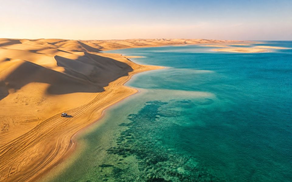 Golden dunes meet the sea at Khor Al Adaid in southern Qatar