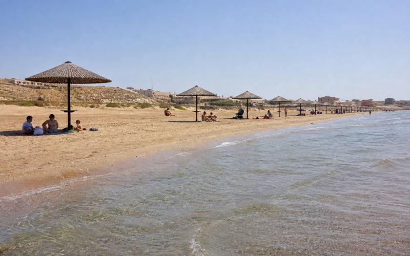 A sandy beach and calm shallow waters of the Caspian Sea near Bilgah