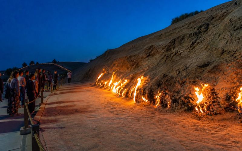 Natural flames on the slope of Mount Yanar Dag in the evening