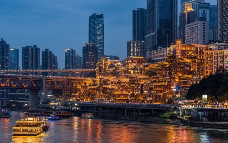 The illuminated Hongyadong complex towers over the river in Chongqing at night
