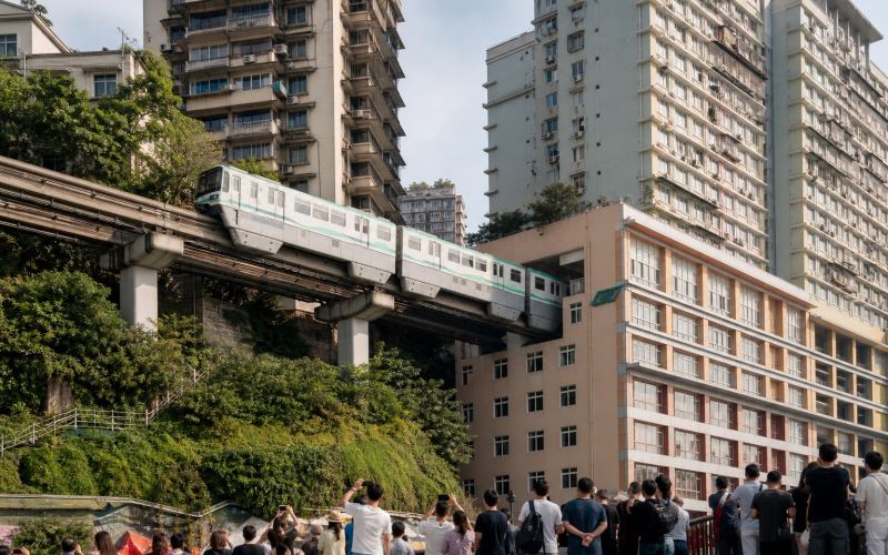 A monorail passes through a residential building at Liziba Station in Chongqing