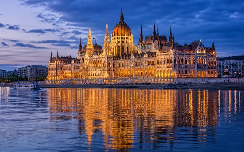 The Hungarian Parliament building is reflected in the Danube in Budapest
