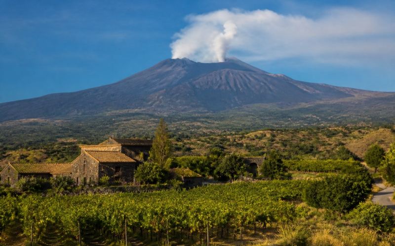 Mount Etna over the vineyards and stone farmsteads of Sicily