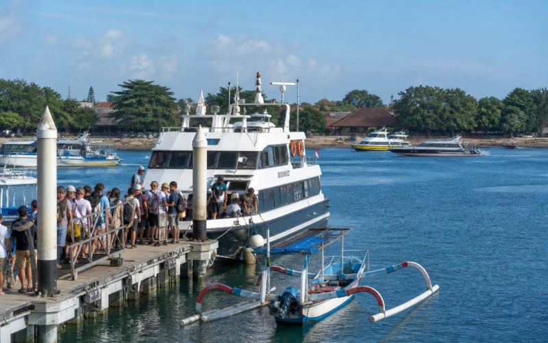 Speedboats and a traditional boat at Sanur Port in Bali