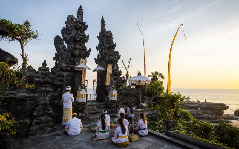 A ceremony at the traditional gates of Petitenget Temple next to the ocean