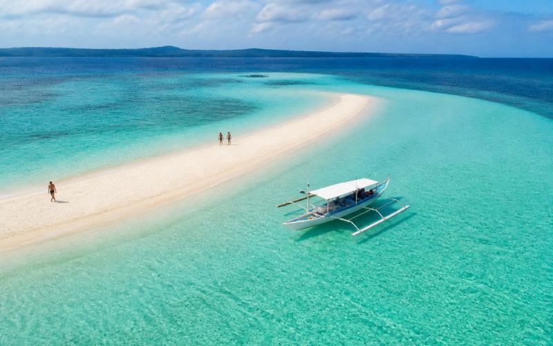 A white sandbar and a boat at Naked Island near Siargao