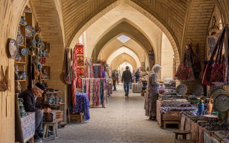 Craft shops selling fabrics and ceramics under the market domes of Bukhara